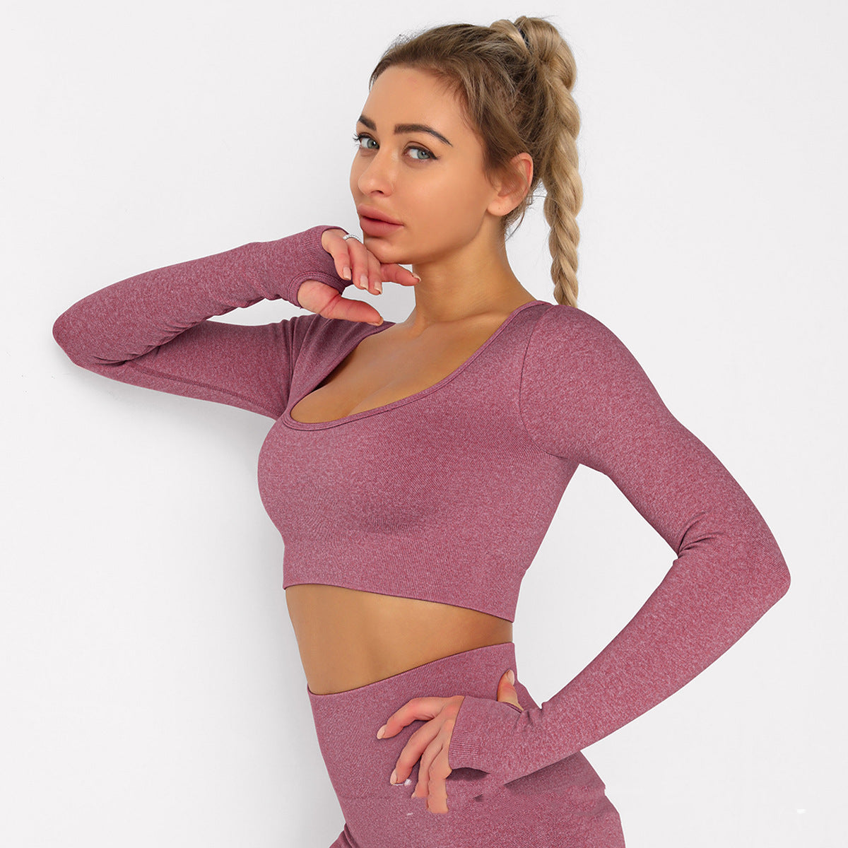 Blond woman standing in pink yoga clothes, sports clothes
