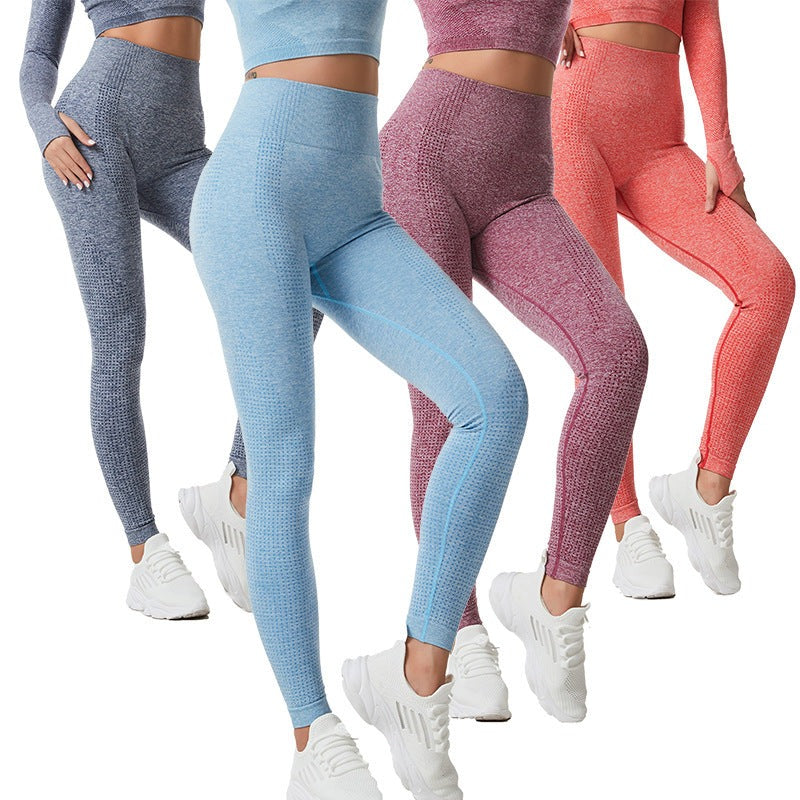 four women standing together wearing tights, all in different colour leggings